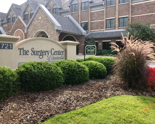 Manicured shrubs and lawn outside The Surgery Center of Huntsville
