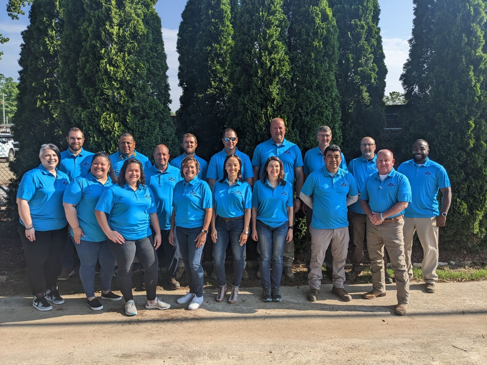 ALM Commercial Landscaping team in matching blue shirts