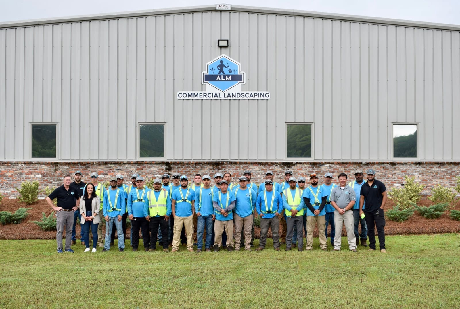 ALM crew in front of the ALM Commercial Landscaping building